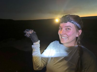photo of CMI project assistant Maggie Johnston holding a bat