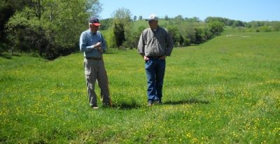 CMI private lands biologist in the field with a landowner.